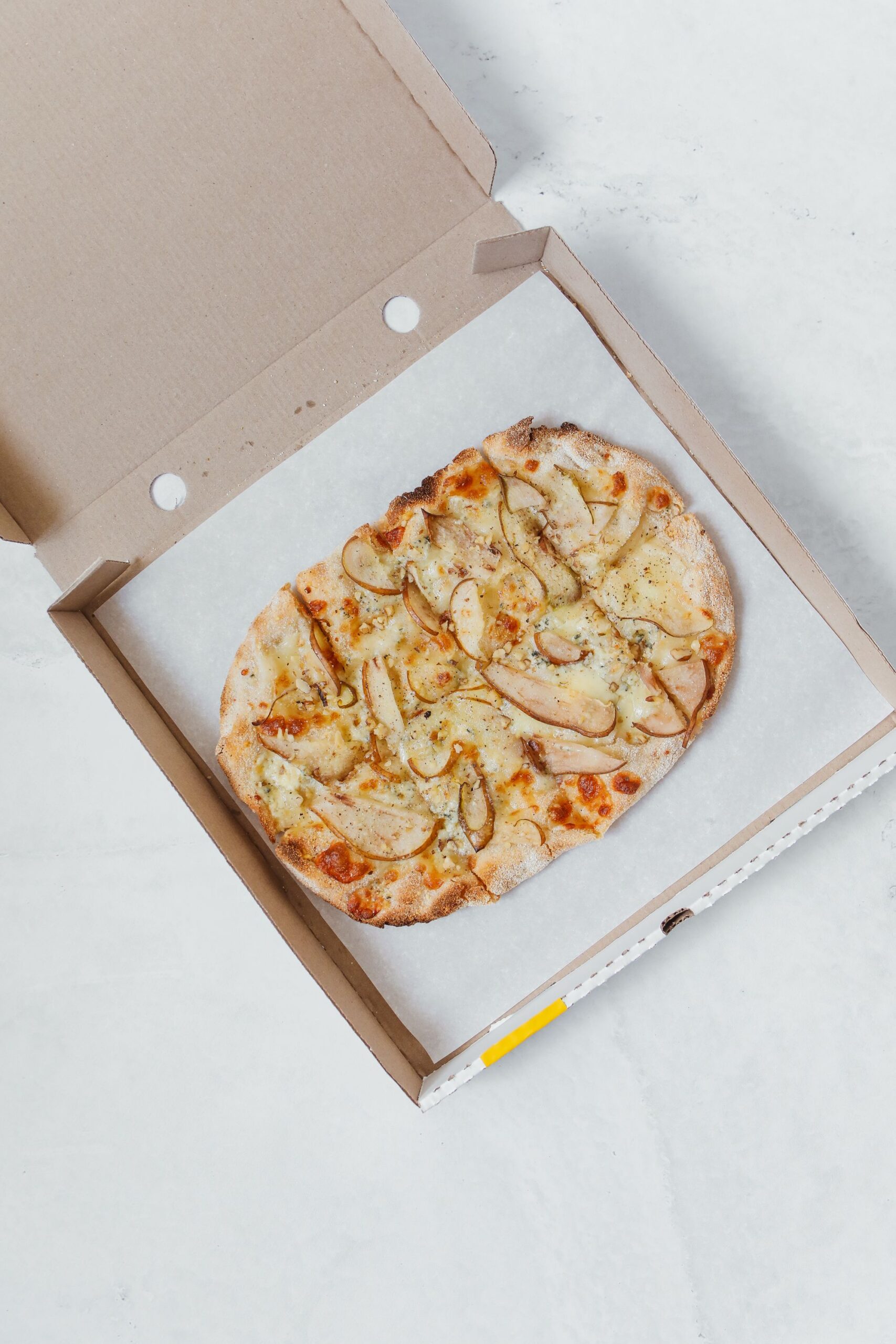 Okrúhla pizza v otvorenej kartónovej krabici